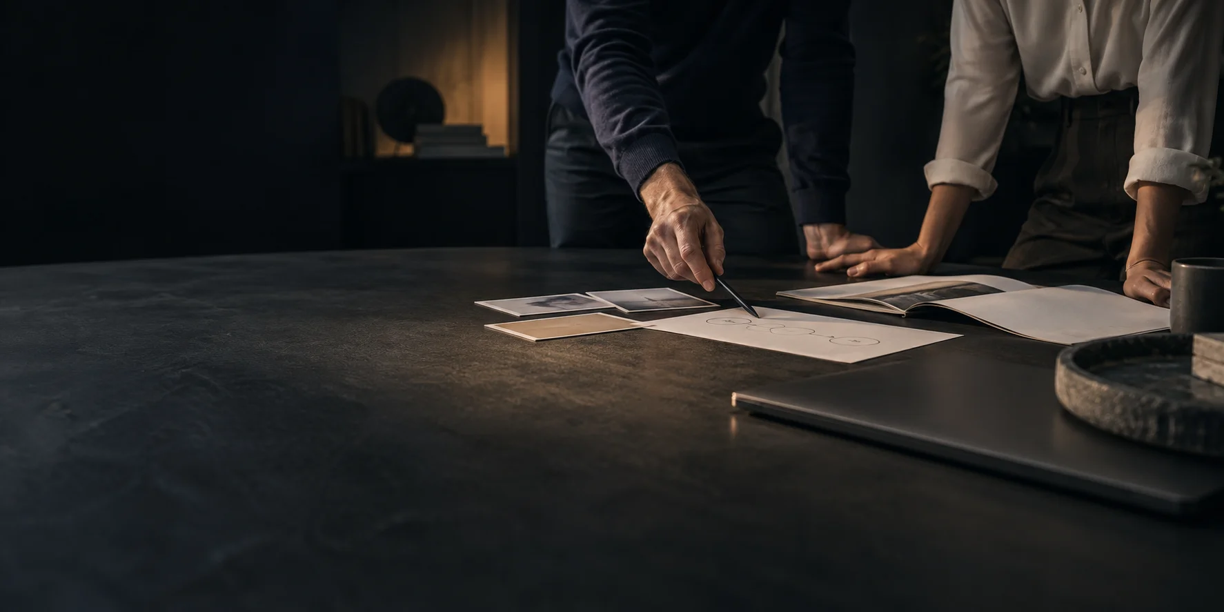 Two people planning project milestones around a table.